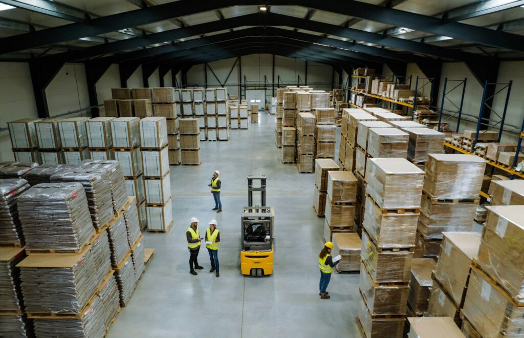 Top view of warehouse workers in warehouse. Team of warehouse workers preparing products for