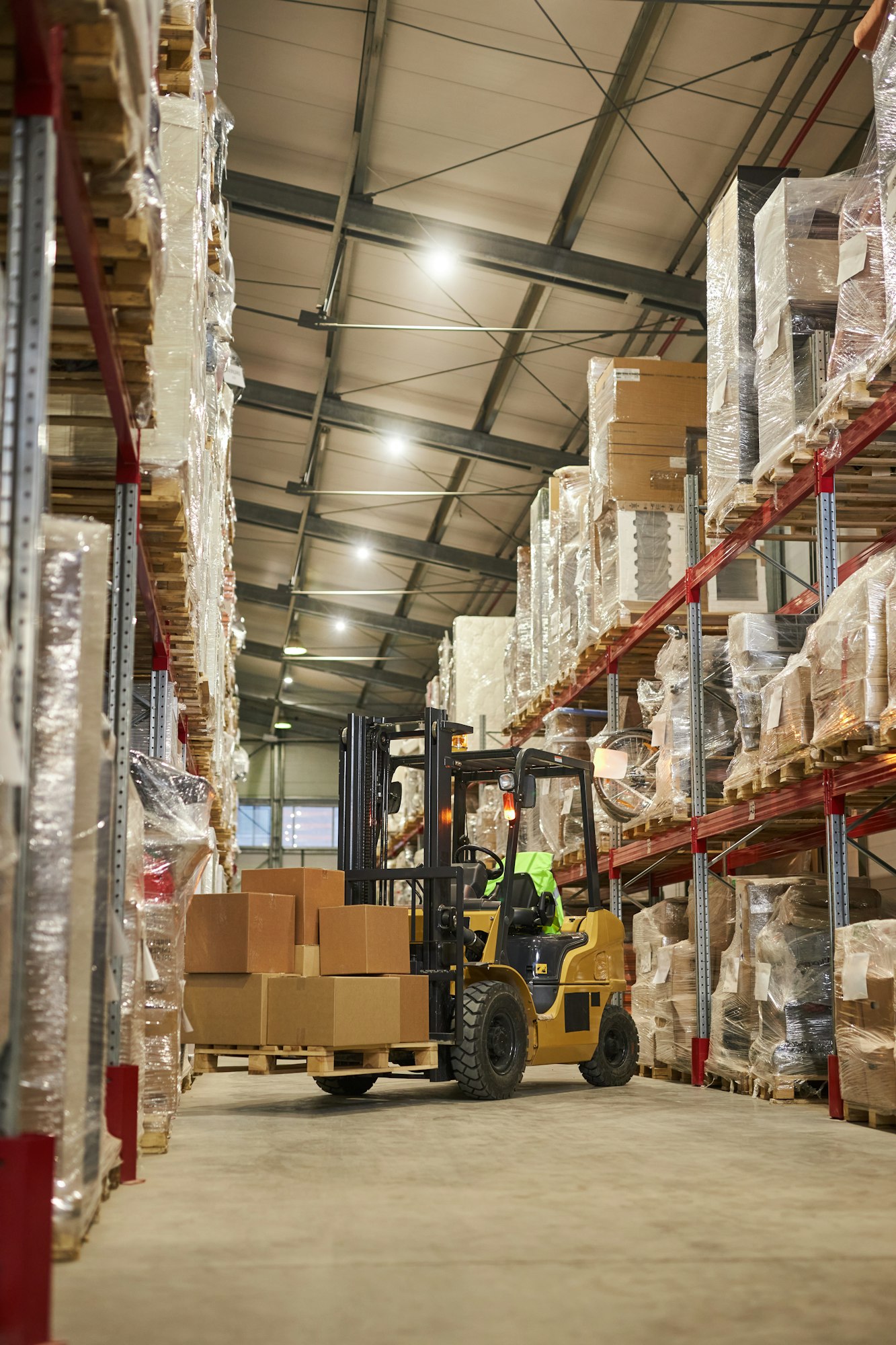 Vertical background image of warehouse interior with forklift